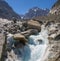 The glacial stream on the glacier Mer de Glace with the Garand Jorasses in the background