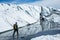 Glacier guide walking along the Matanuska Glacier amng walls of ice and mud flats below