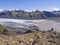 Glacier lagoon with icebergs and tongue of Skaftafellsjokull, valley Morsardalur river and colorful rhyolit mountains in