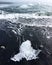 Glacier Lagoon Jokulsarlon, black volcanic beach with a piece of crystal ice