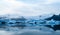 Glacier lake with icebergs with mountain and glacier in the background in Fjallsarlon, Iceland