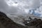 Glacier on rocky mountains. Melting glaciers due to global warming climate change problem. Barskoon mountain pass. Travel tourism