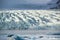 Glacier tongue between the mountains coming into glacial lake, Vatnajokull glacier, Fjallsarlon lagoon, Iceland