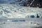 Glacier tongue between the mountains coming into glacial lake, Vatnajokull glacier, Fjallsarlon lagoon, Iceland