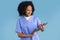 Glad black millennial lady nurse in uniform typing on tablet, work with technology