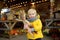 Glad boy holding colorful ears of indian corn at the seasonal agricultural fair