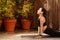 Glad calm millennial european woman athlete in sportswear practicing yoga in city, enjoy sun