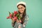 glad child in beret with tulips. mothers or womens day. kid in glasses hold flowers