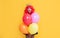glad child in crown with party balloon on yellow background