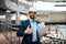 Glad confident millennial islamic guy engineer in protective helmet, suit with beard with project drawings