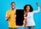 Glad emotional millennial african american couple celebrate victory with hands gesture, show big phone with empty screen