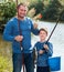 Glad father and son fishing with rods