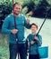 Glad father and son fishing with rods