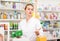Glad female druggist working in pharmacy