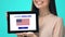 Glad female holding tablet with learn English app, USA flag on screen, education