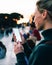 Glad female tourist looking on smartphone during walk around city