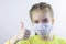 Glad and happy beautiful joy,child in the medical helthcare guarding or protecting mask and in yellow t-shirt