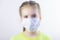 Glad and happy beautiful joy,child in the medical helthcare guarding or protecting mask and in yellow t-shirt
