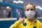 Glad and happy beautiful joy child in the medical helthcare guarding or protecting mask and in yellow t-shirt in subway