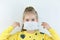 Glad and happy beautiful joy,child taking medical helthcare guarding or protecting mask and in yellow t-shirt