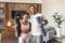 Glad happy young black wife and husband in sportswear with mats ready for workout together in living room