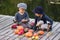 Glad kids paint small Halloween pumpkins