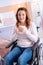 Glad lovely disabled woman holding a cup