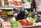 Glad male seller showing assortment of grocery shop