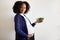 Glad millennial african american pregnant lady with big belly hold salad on gray wall background