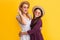 glad mother and daughter in straw hat on yellow background