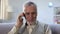 Glad pensioner talking on phone with close relatives, cheap mobile provider