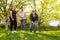 Glad, positive smiling family playing French traditional game petanque in the garden outside during lovely summer day