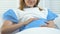 Glad pregnant woman stroking belly lying hospital bed, prenatal care, parenting