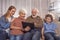 Glad relatives watching at digital device