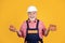 glad senior man worker in hard hat on yellow background