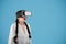 Glad surprised teen european girl student with pigtails in vr glasses look at copy space