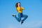 glad teen girl jump high on sky background