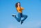 glad teen girl jump high on sky background