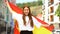 Glad teenager female waving flag of Spain and smiling young, national holiday