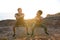 Glad young african american girlfriend and man in sportswear squatting on ocean beach, enjoy morning