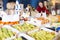 Glad young customer selecting fruits in grocery