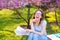 Gladden female student reading papers and studying in spring park.