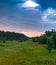 Glade green wood and blue sky with clouds