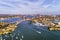 Gladesville bridge across Parramatta river in Sydney`s Inner West with distant view of the city CBD on the horizon. Speed boats