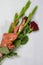 Gladiolas and roses on stalks of green leaves