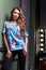 Glamor fashion model young actress luxury life style wear colorful blouse black pants dressing room stand next to mirror with