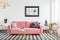 Glamor living room interior with a pink sofa, golden armchair an