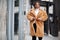 Glamorous african american woman in warm fur coat, eyeglasses pose at street