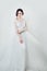 Glamorous bride portrait. Perfect woman in white stylish dress