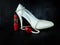 Glamorous composition made of white heels, red lipstick and pearl necklace